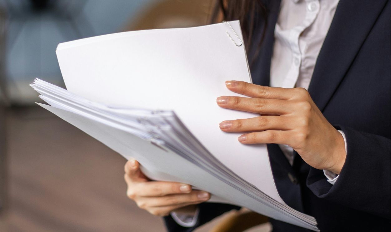 Woman in Black Blazer Holding White Papers