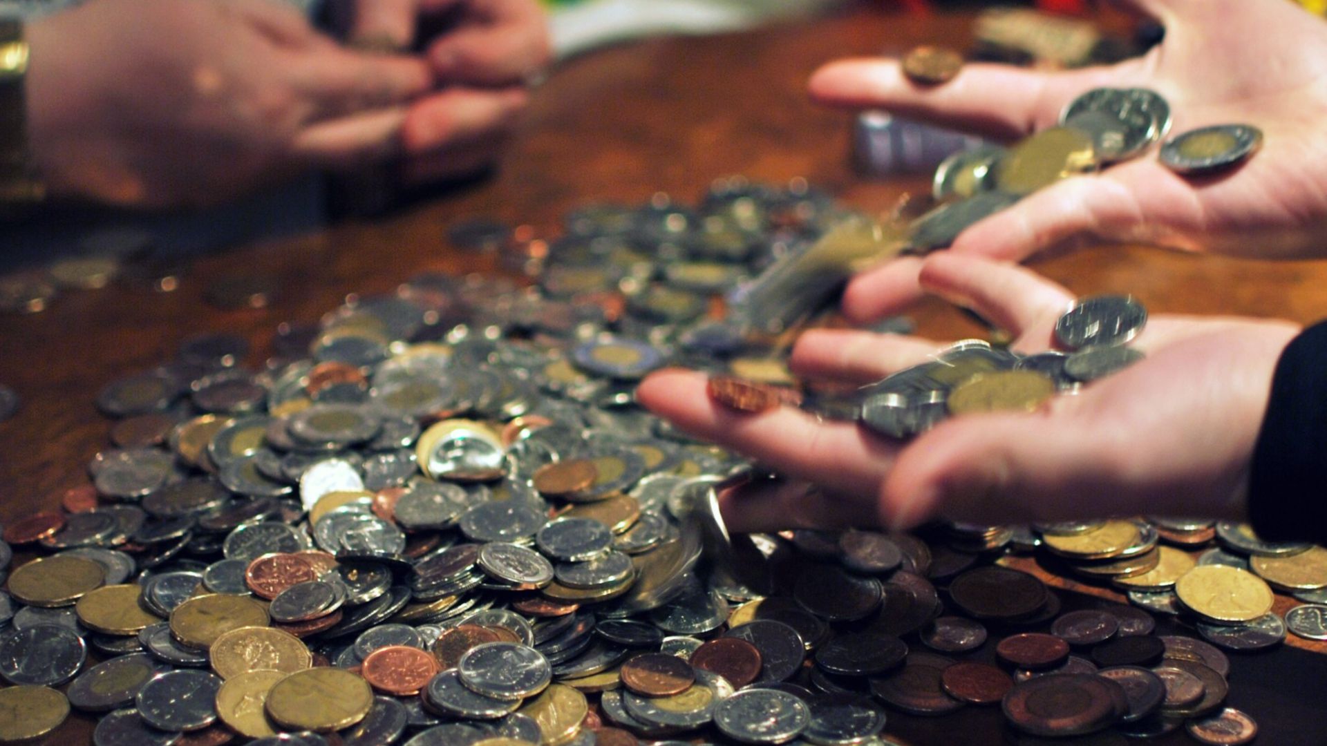 Girls rolling coins for today's tip share.    I told Erin to put her hands the pile to capture them both working on sorting through this mess, and this is what she did instead.  Silly girl.