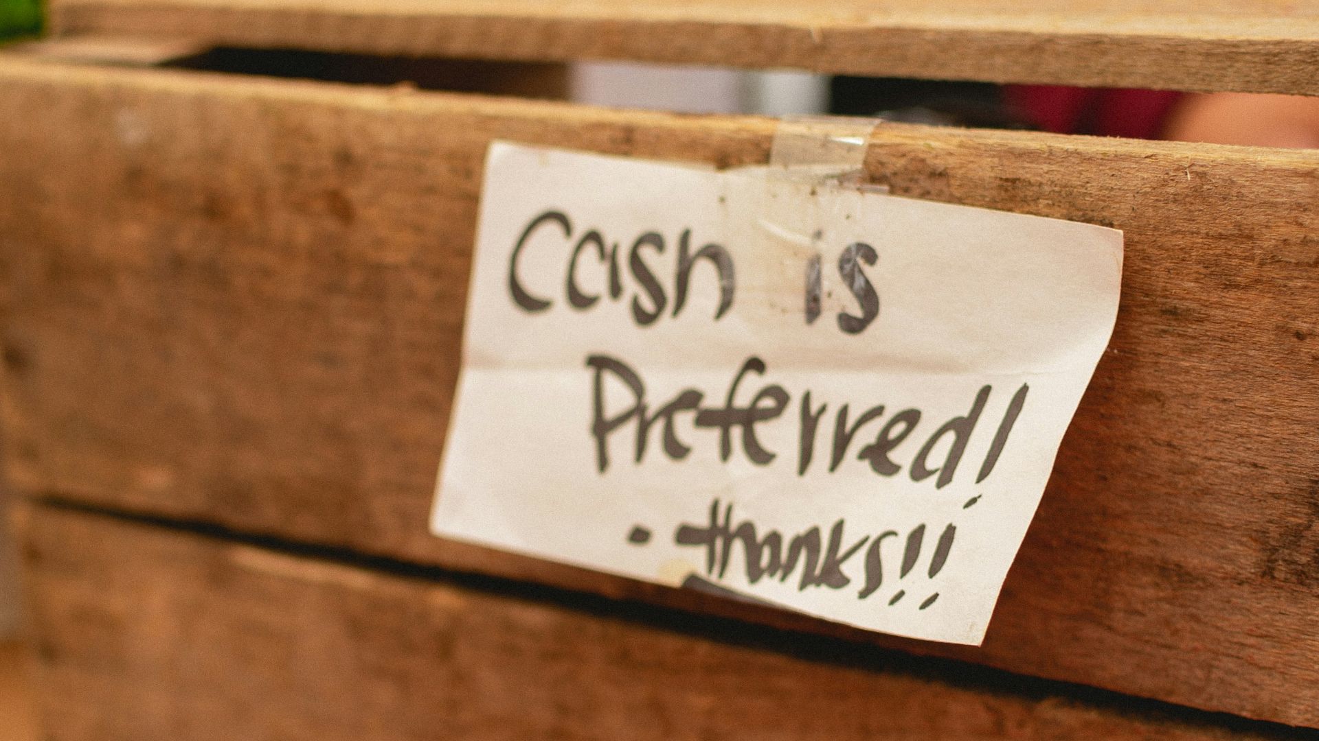 a close up of a wooden box with a sign on it