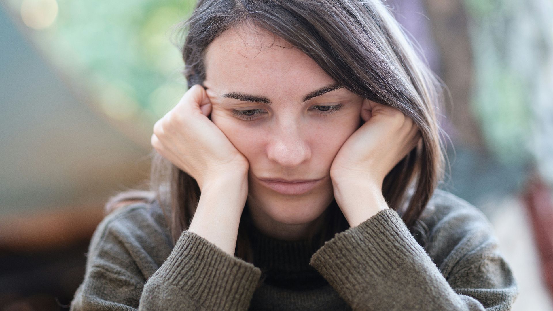 a woman holding her head in her hands