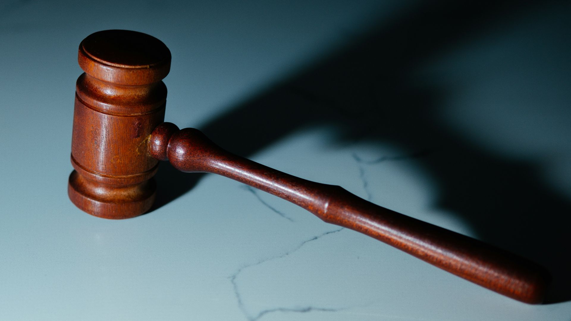 a wooden judge's hammer sitting on top of a table