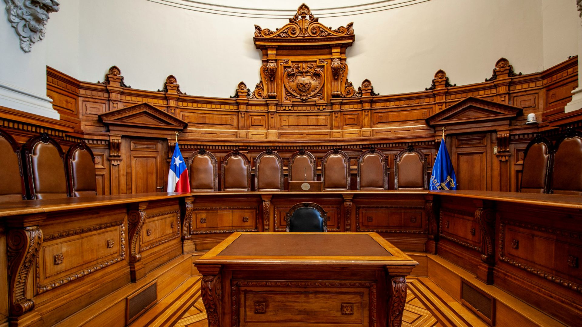 a courtroom with a large wooden bench