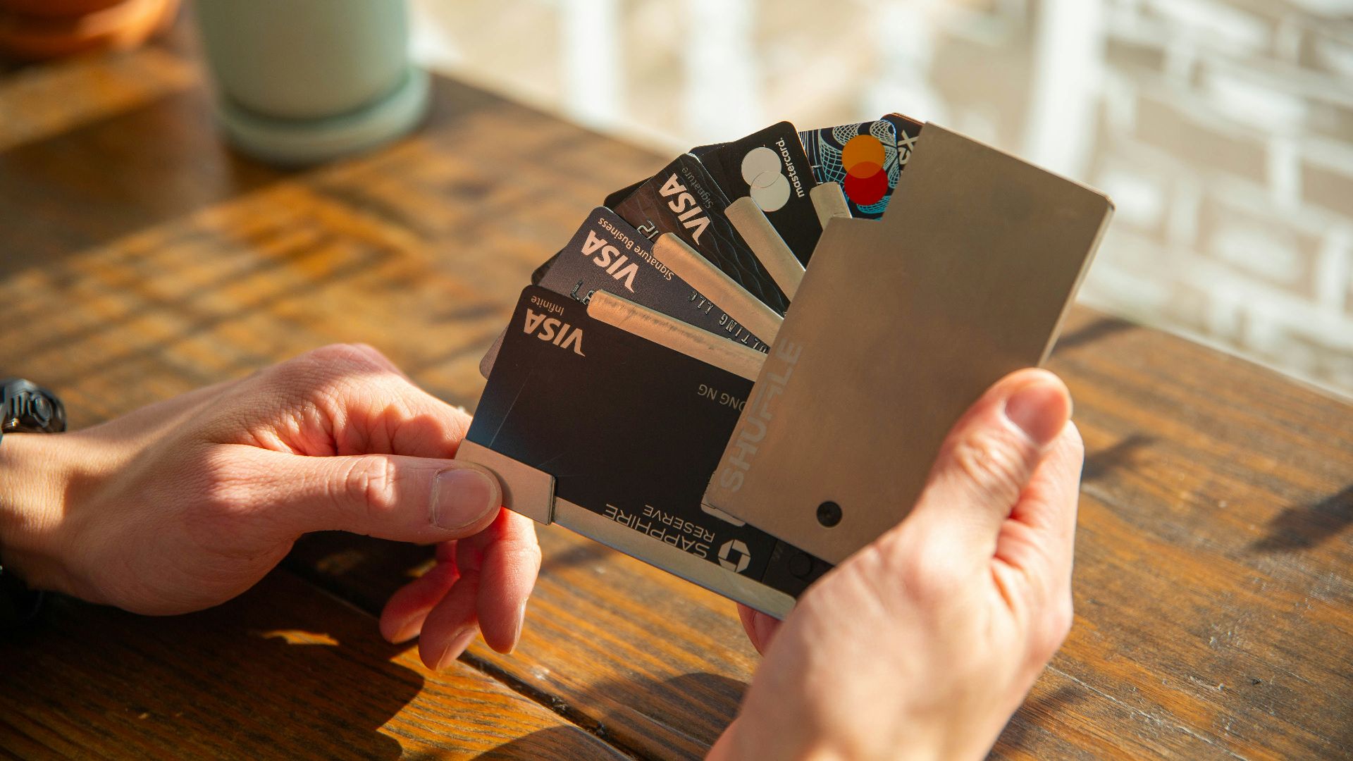 a person holding a credit card in their hand