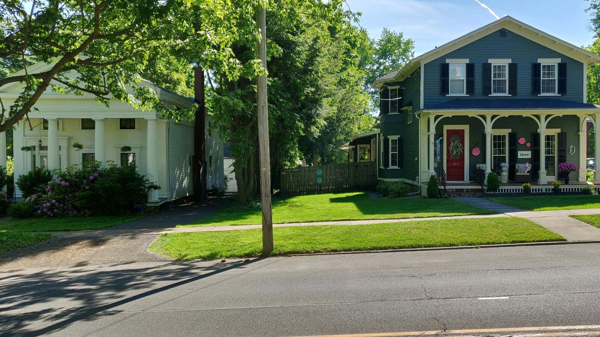 green grass lawn near white and red house during daytime