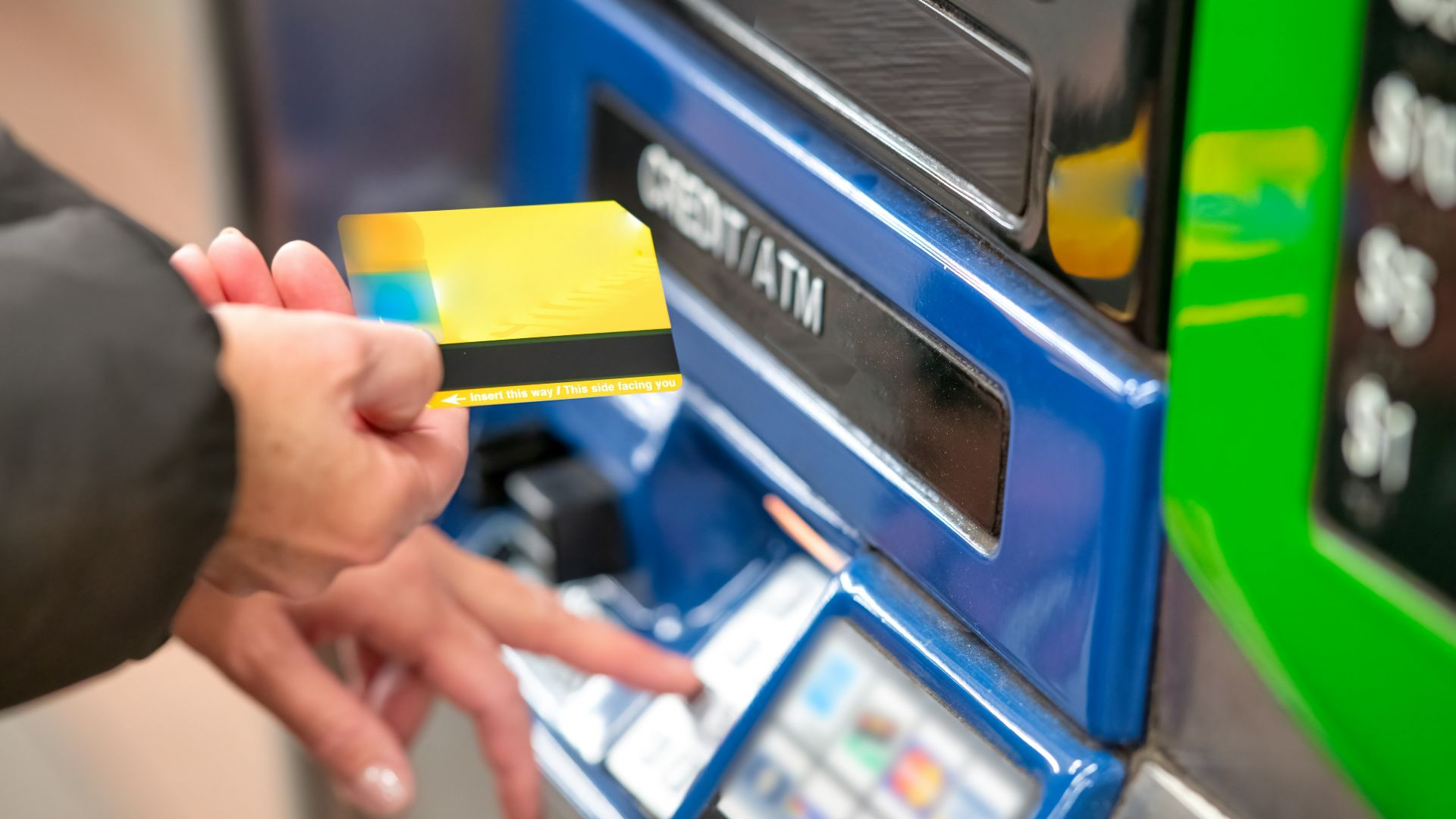 a person using a credit card to pay for a machine