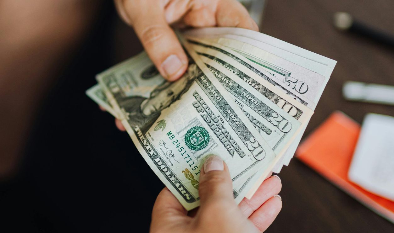 Money Handed Over from Hand to Hand