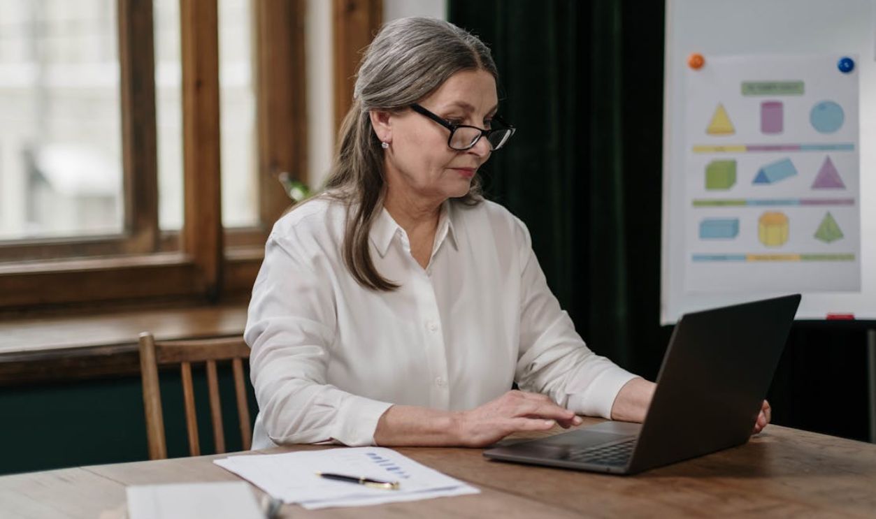 Woman with Black Framed Eyeglasses using Laptop