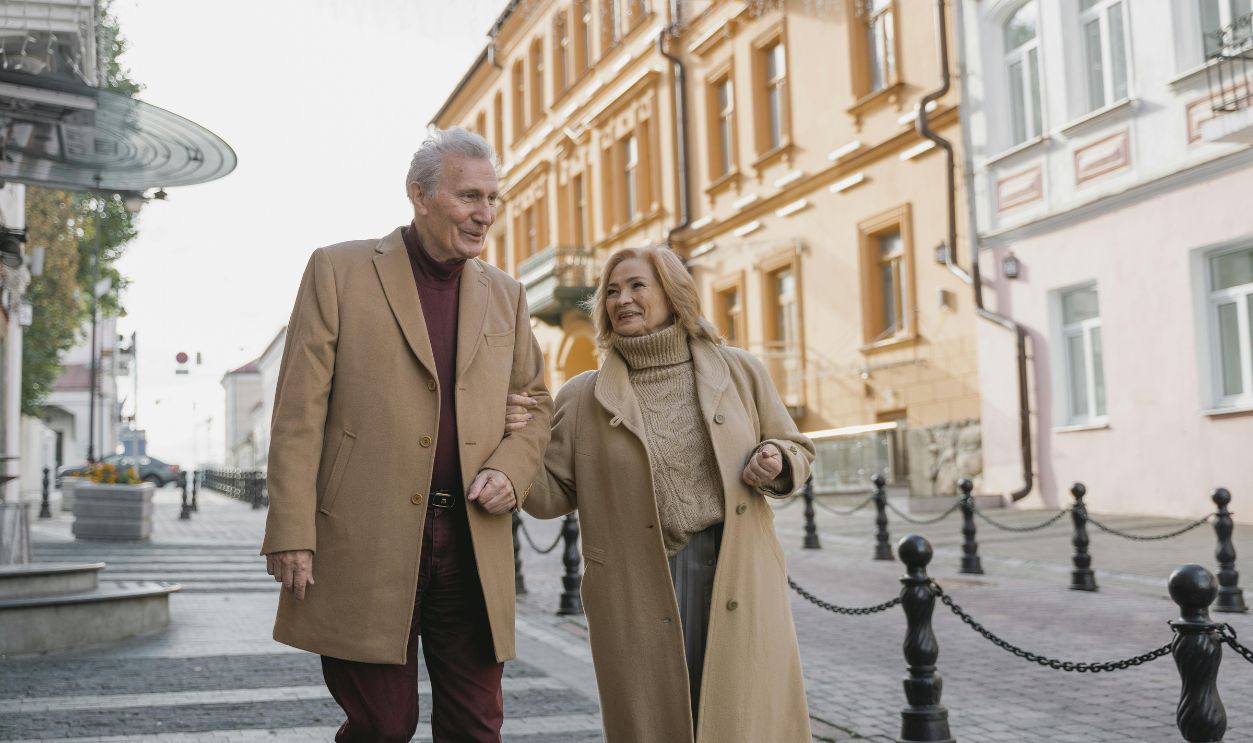 An Elderly Couple Waling on the Street Sidewalk