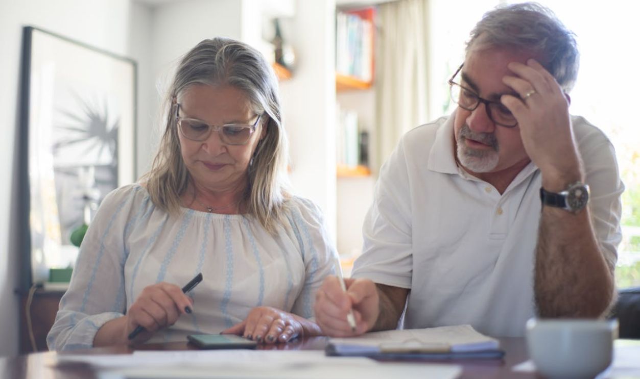 Elderly Couple Making Notes