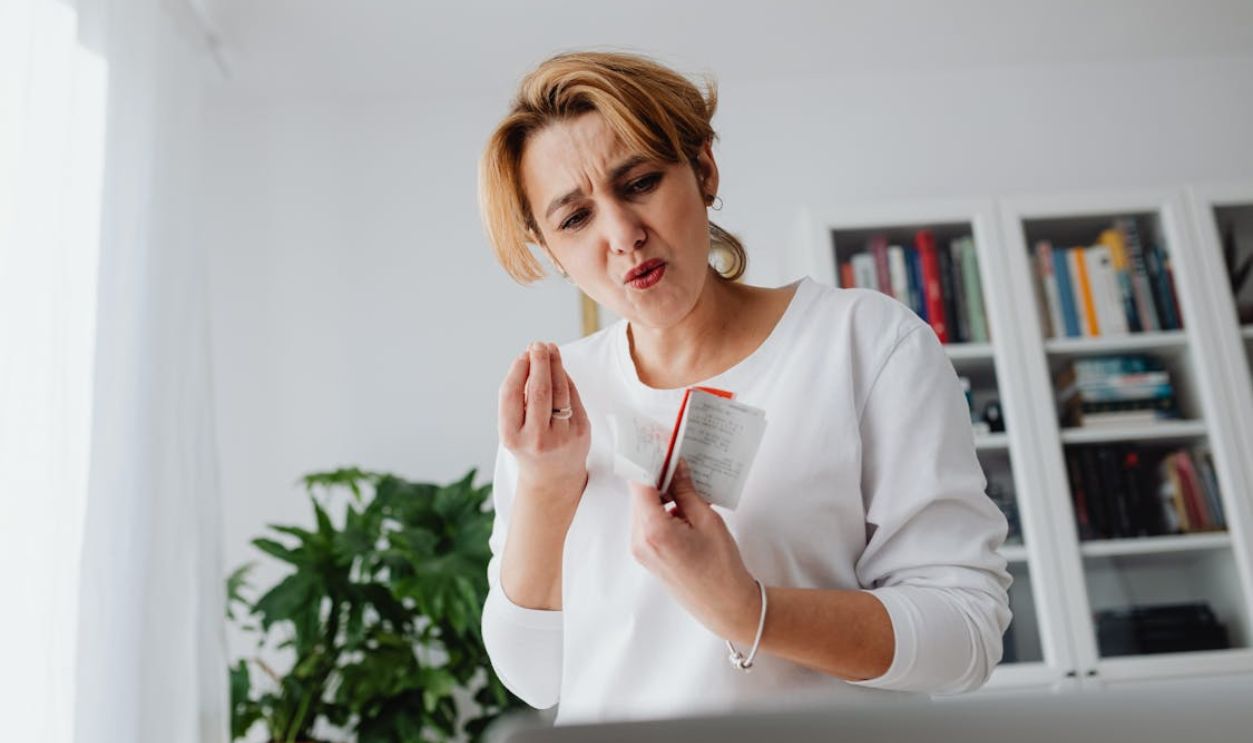 Surprised and Upset Woman Holding a Bunch of Receipts