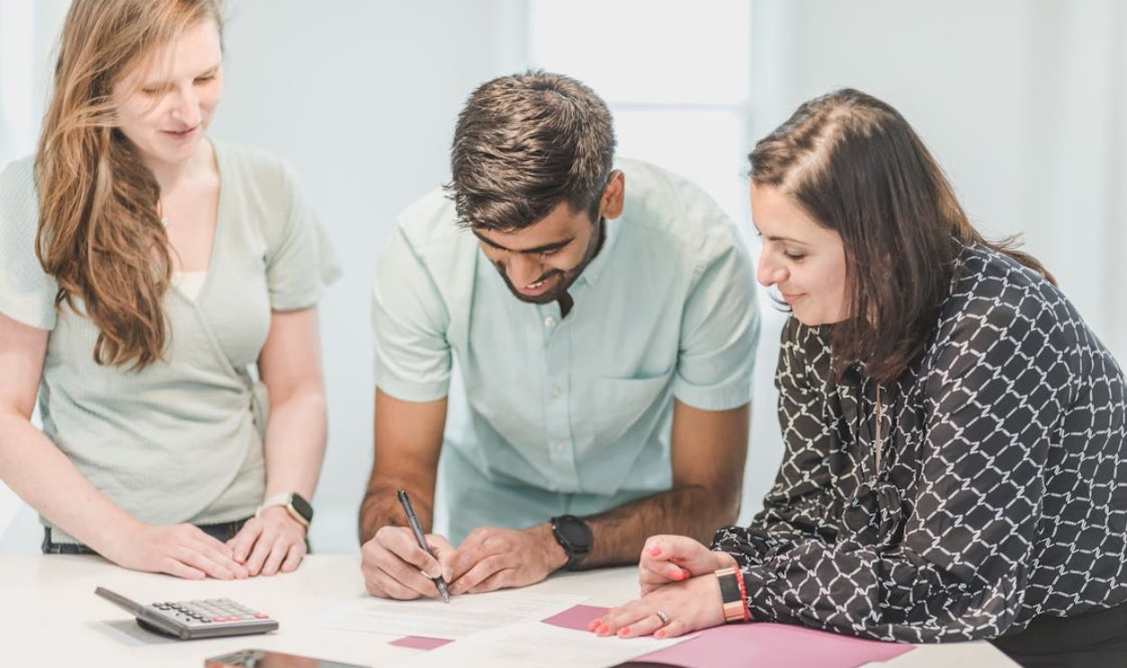 A Man Signing a Document