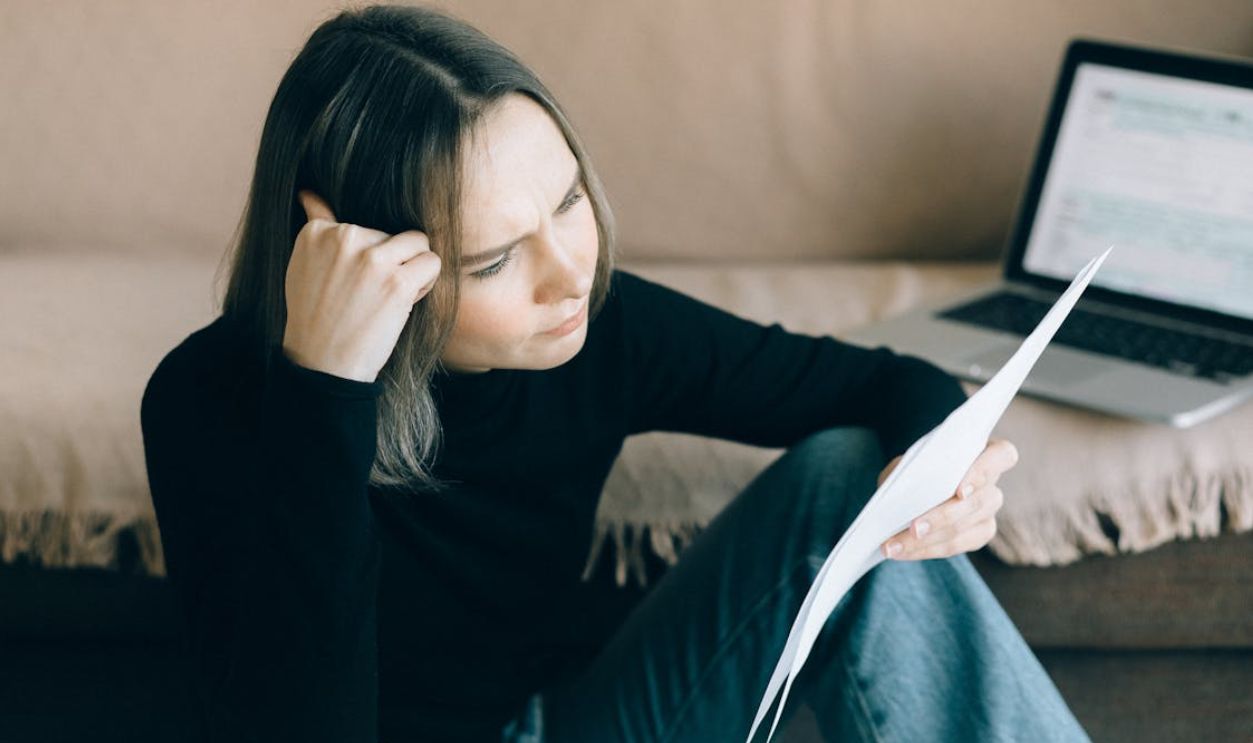 Woman in Black Long Sleeves Shirt Holding Papers