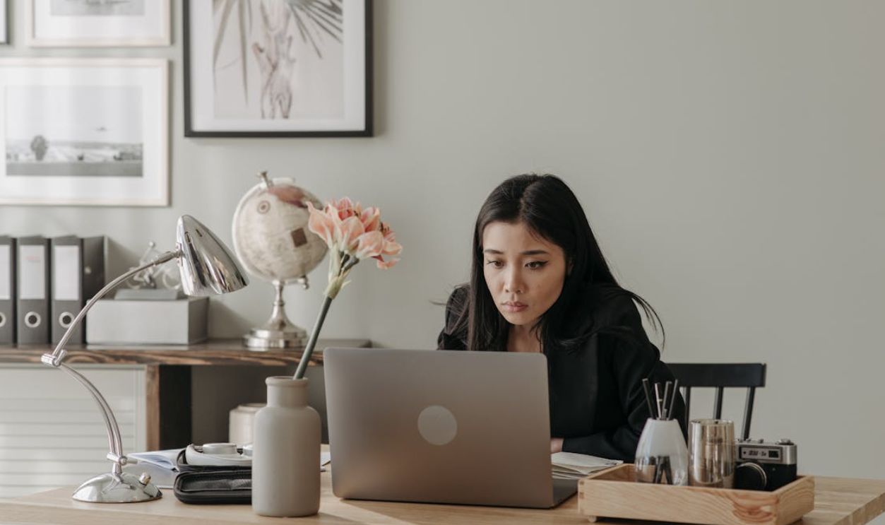 Woman in Black Long Sleeve Shirt Using Laptop