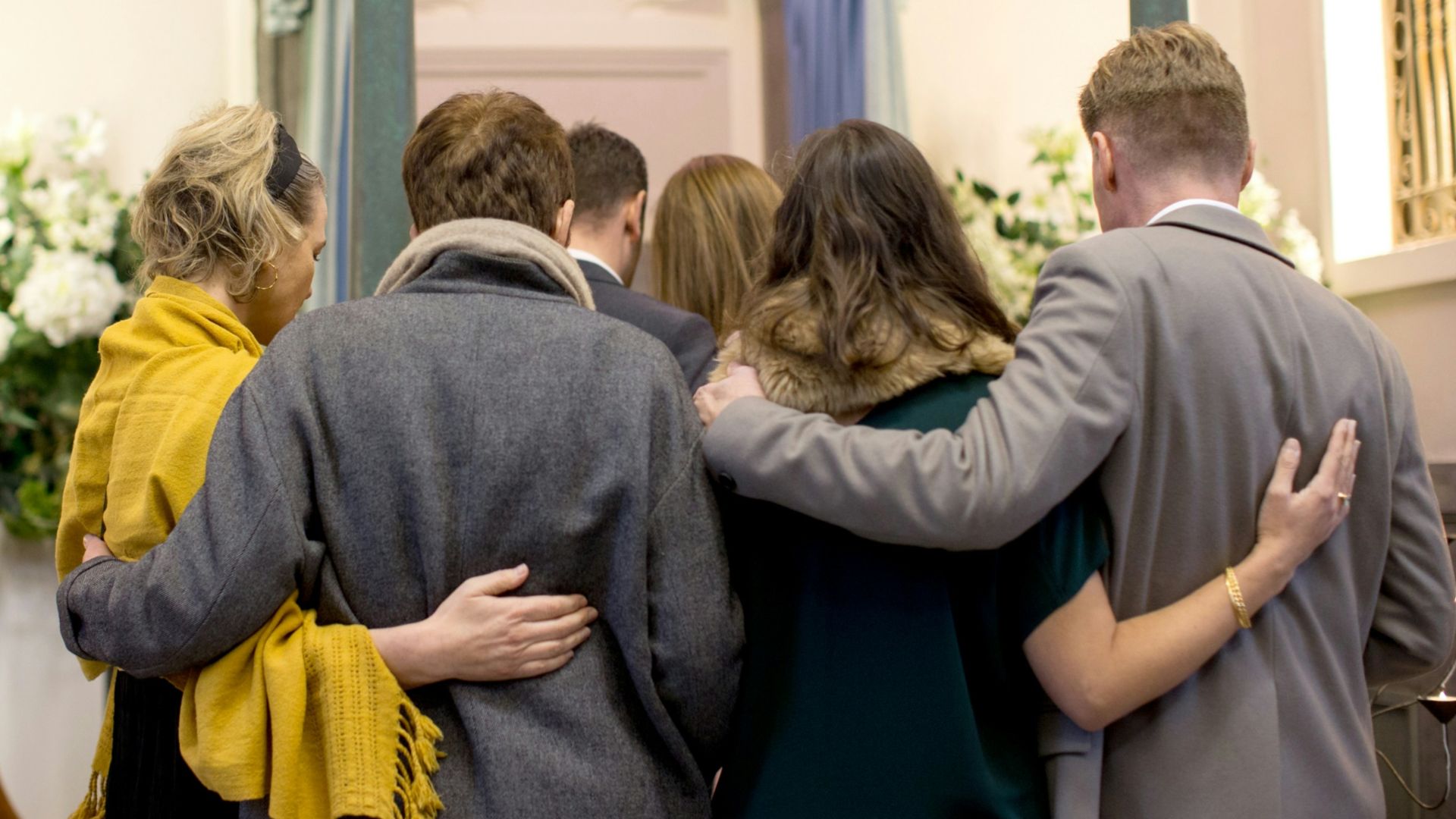 a group of people standing in front of a doorway