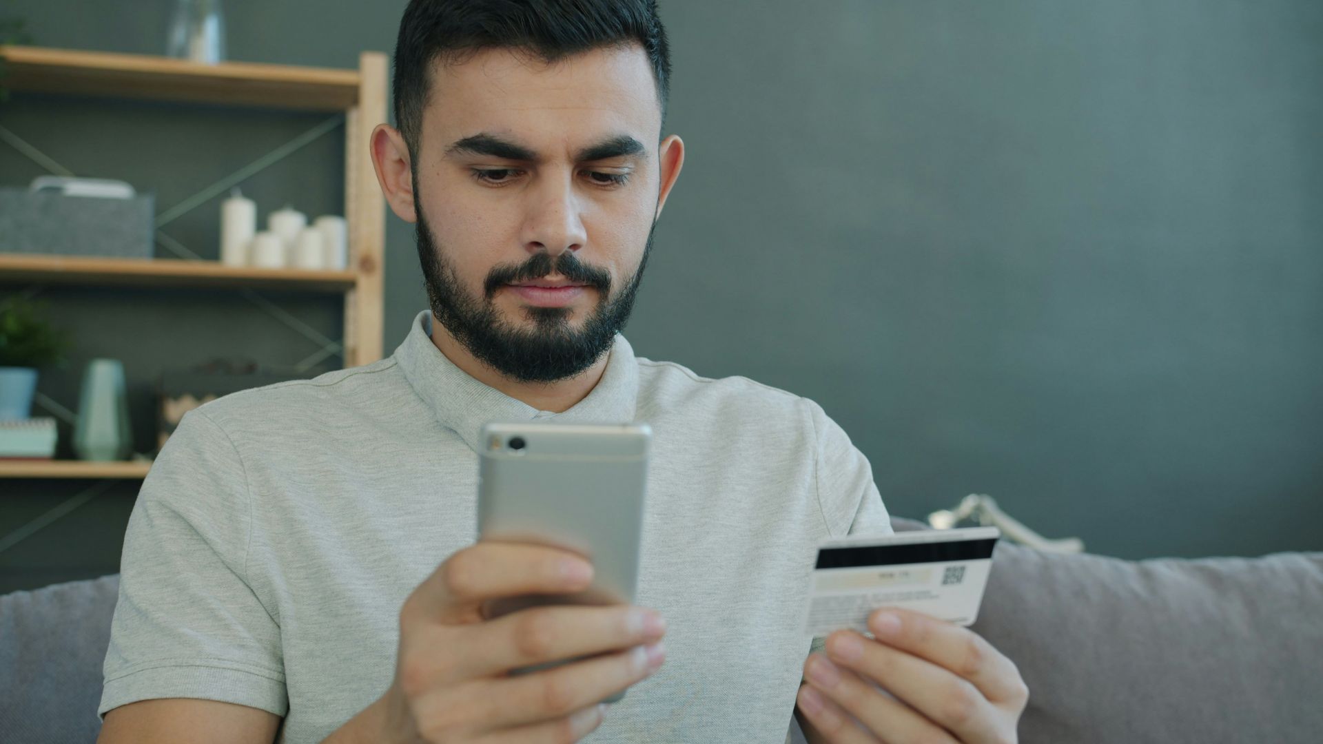 Man holding phone and credit card for online shopping