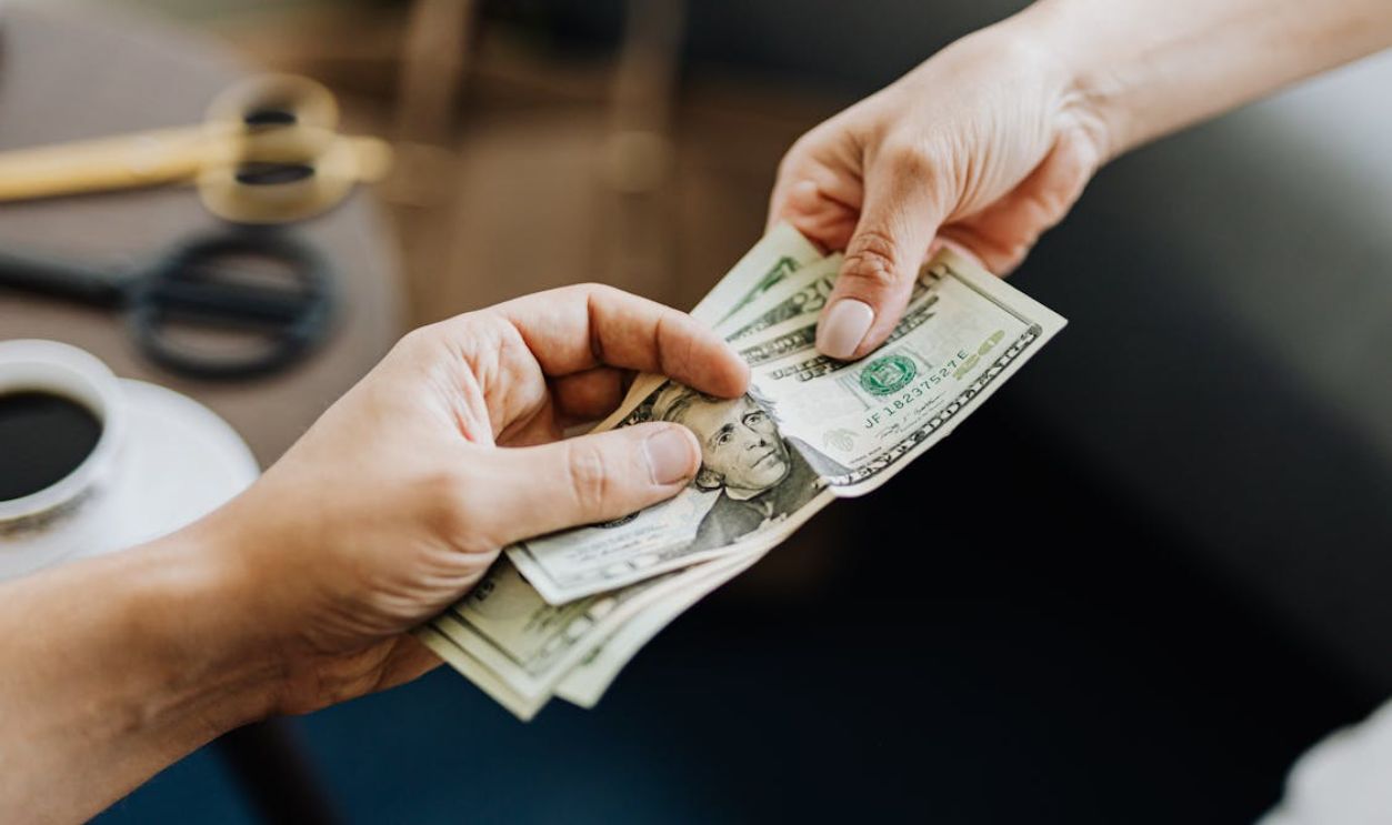 Hands Holding Us Dollar Bills