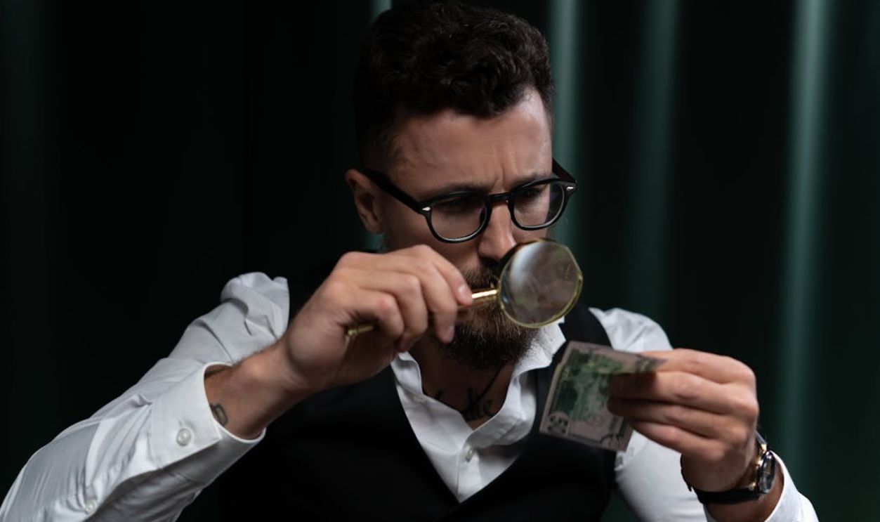 Meticulous Man using Magnifying Glass