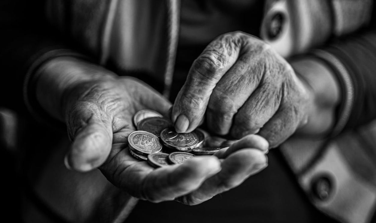 Elderly Person Hands Holding Coins