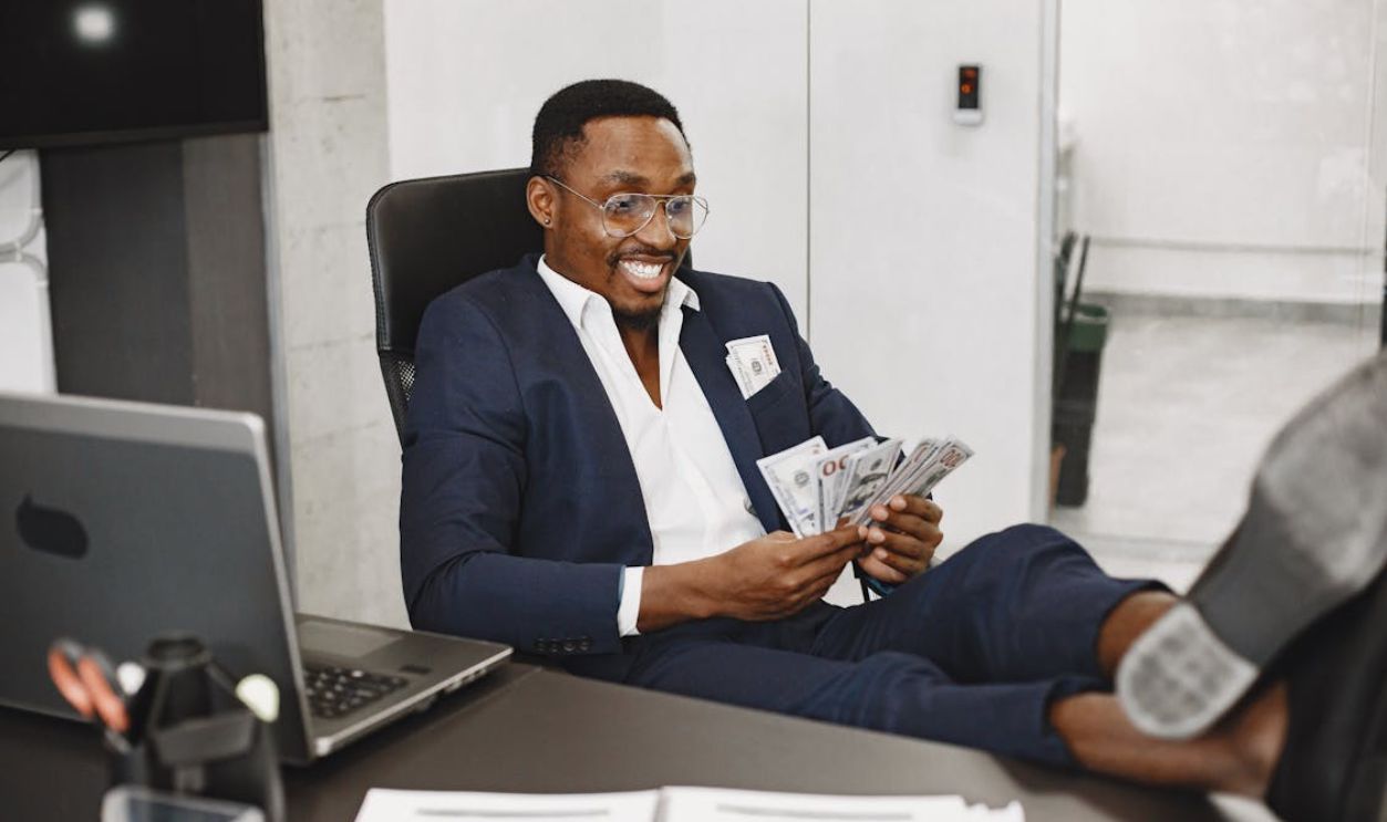 Happy Elegant Man With Money in Office