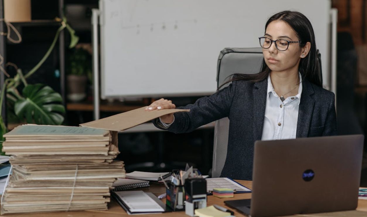 A Boss Holding a Brown Folder
