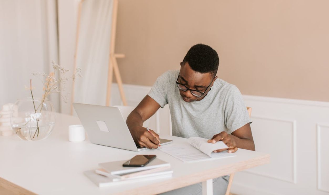 A Man in Gray T-shirt Writing