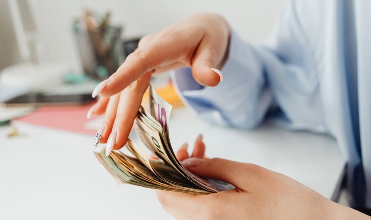 Person Holding American Dollars