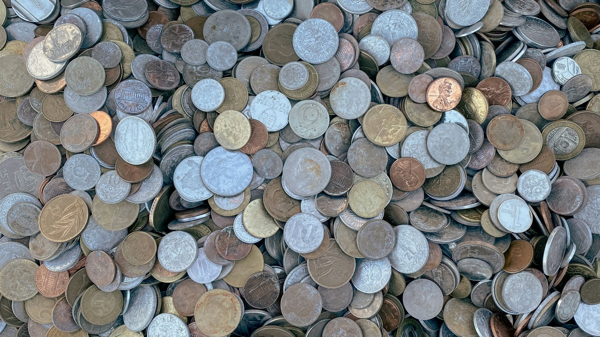 a pile of different types of coins