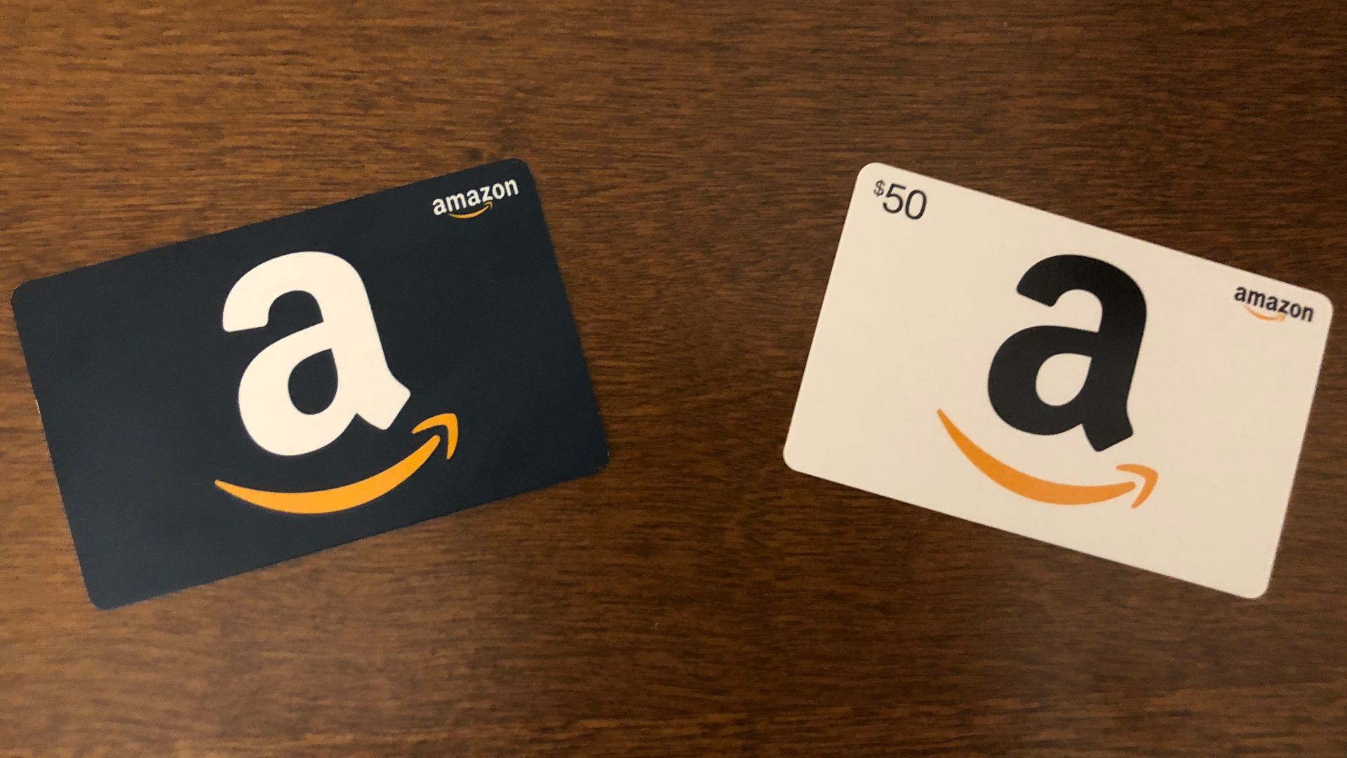 black and white Amazon Gift Cards next to each other