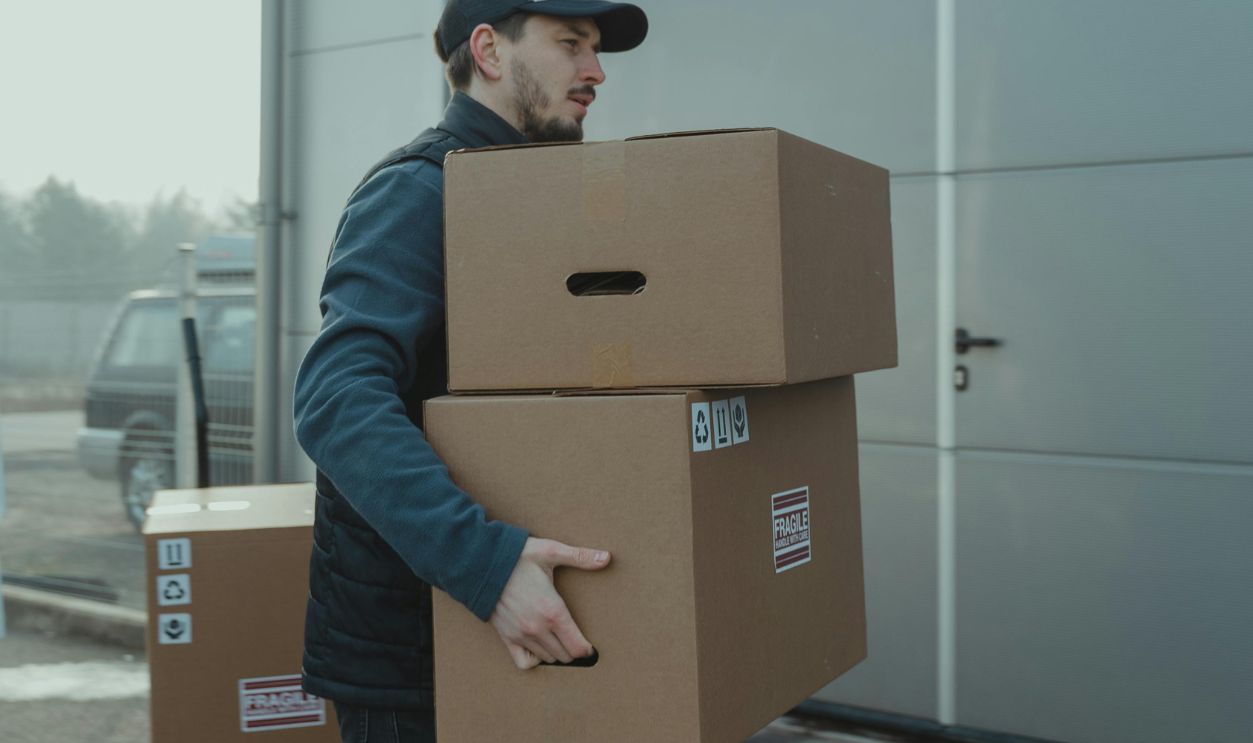 Delivery Man carrying Carton Boxes