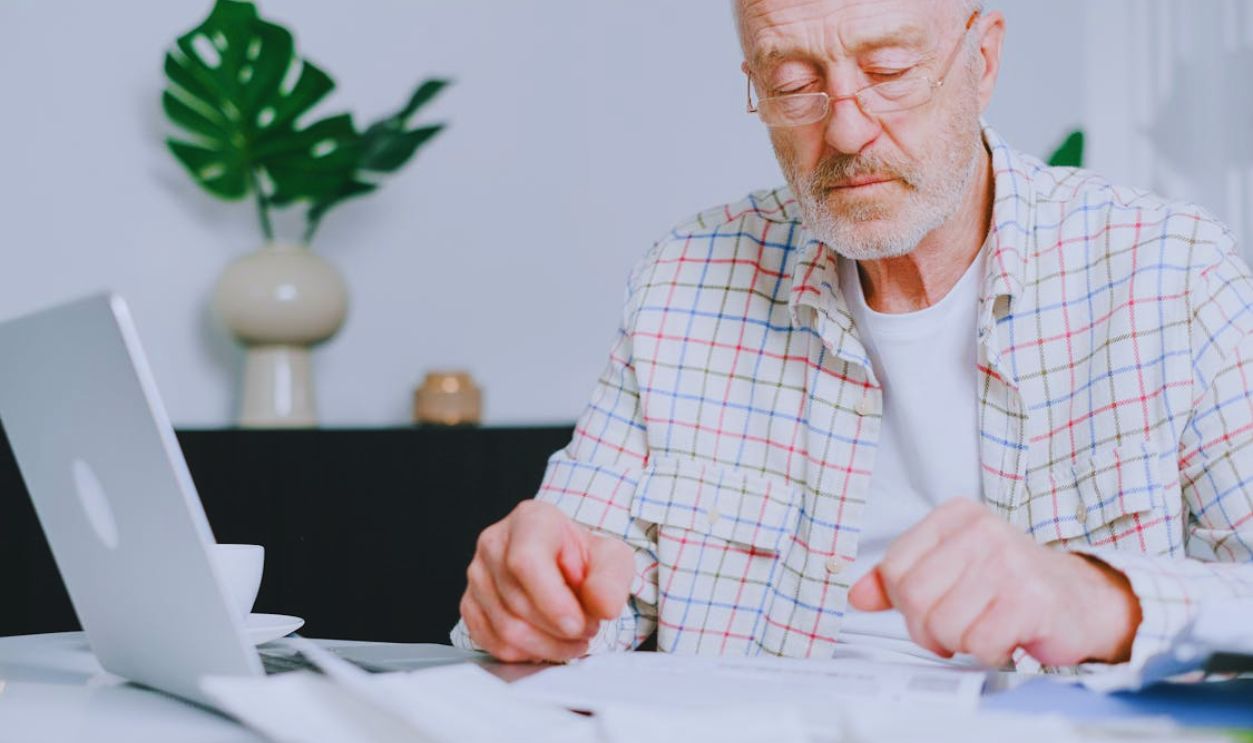 An Elderly Man Looking at the Table