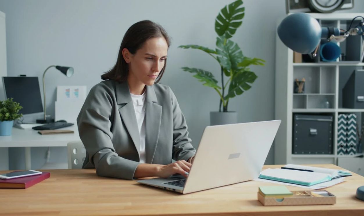 Professional woman working at home office desk