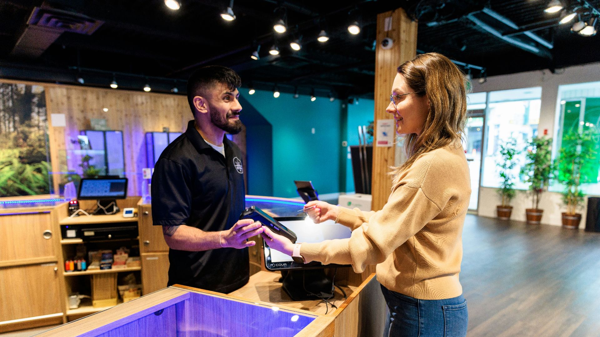 a man and a woman standing in front of a fish tank