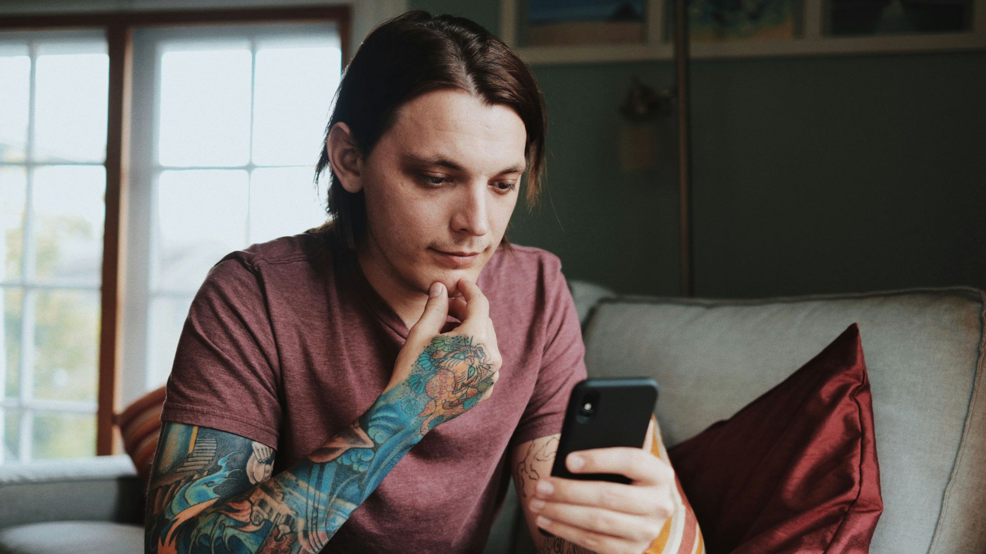 man using Android smartphone]