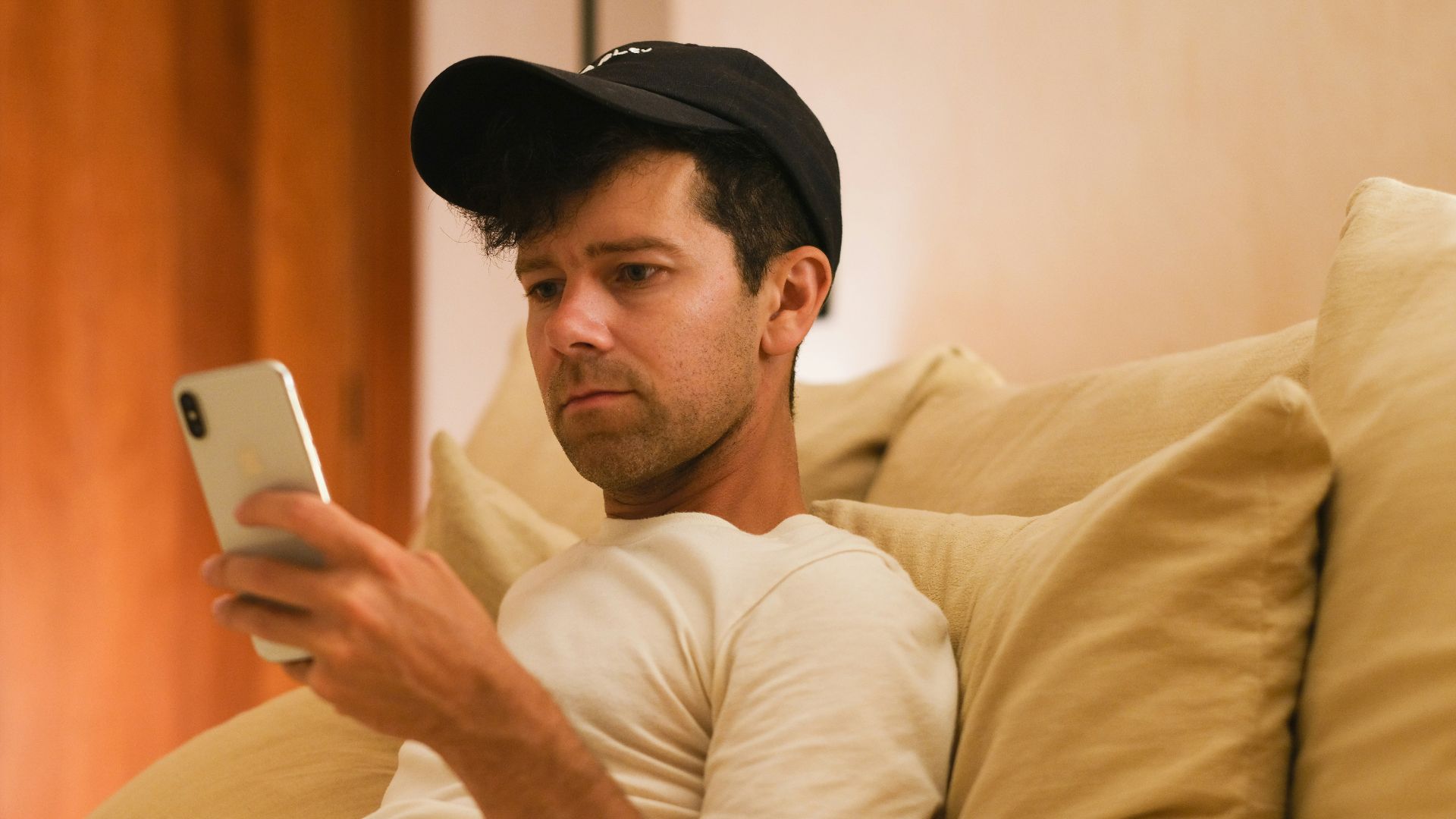 A man is focused on his phone.