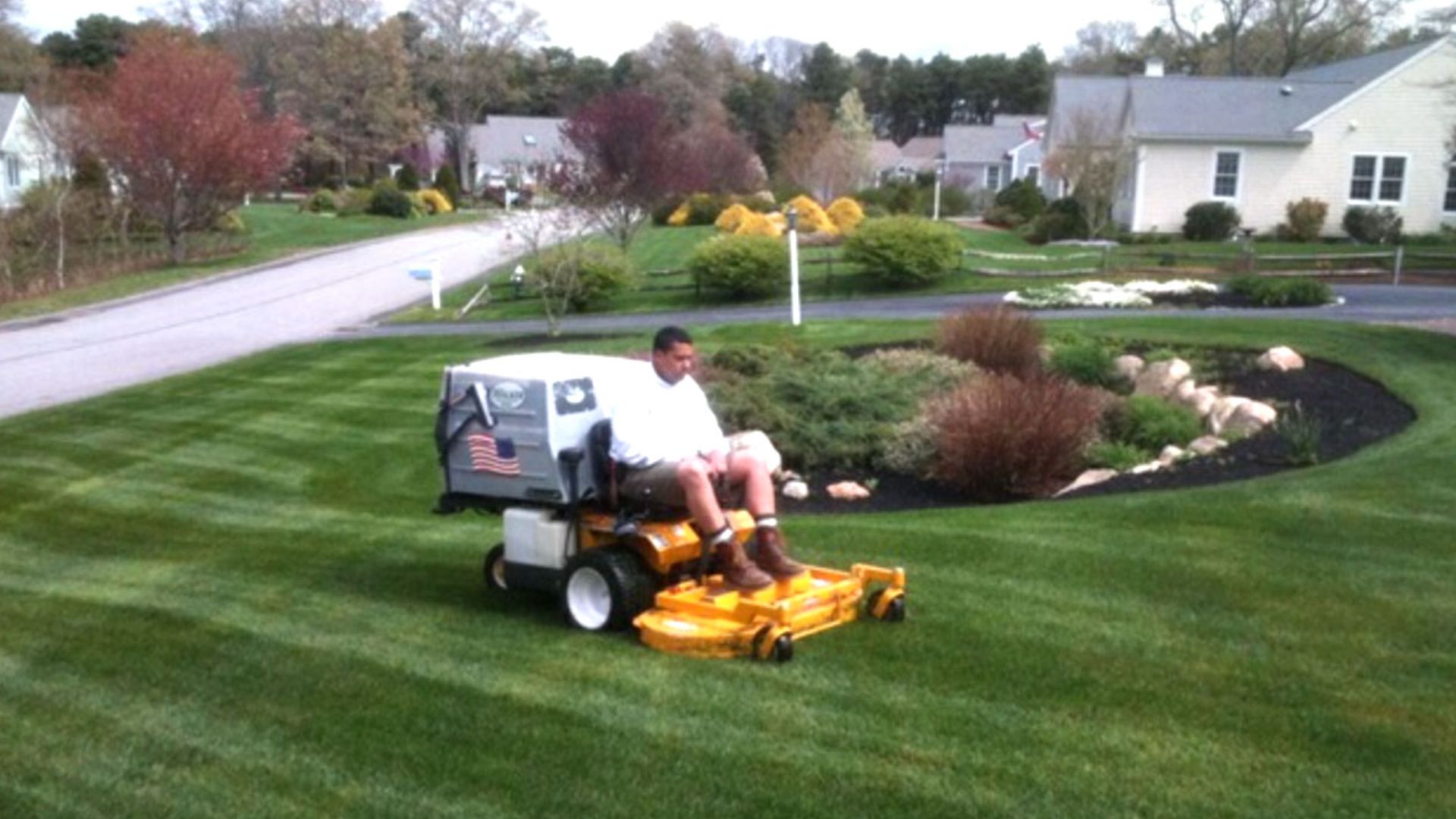 Man mowing a lawn at a home in Cape Cod, Massachusetts