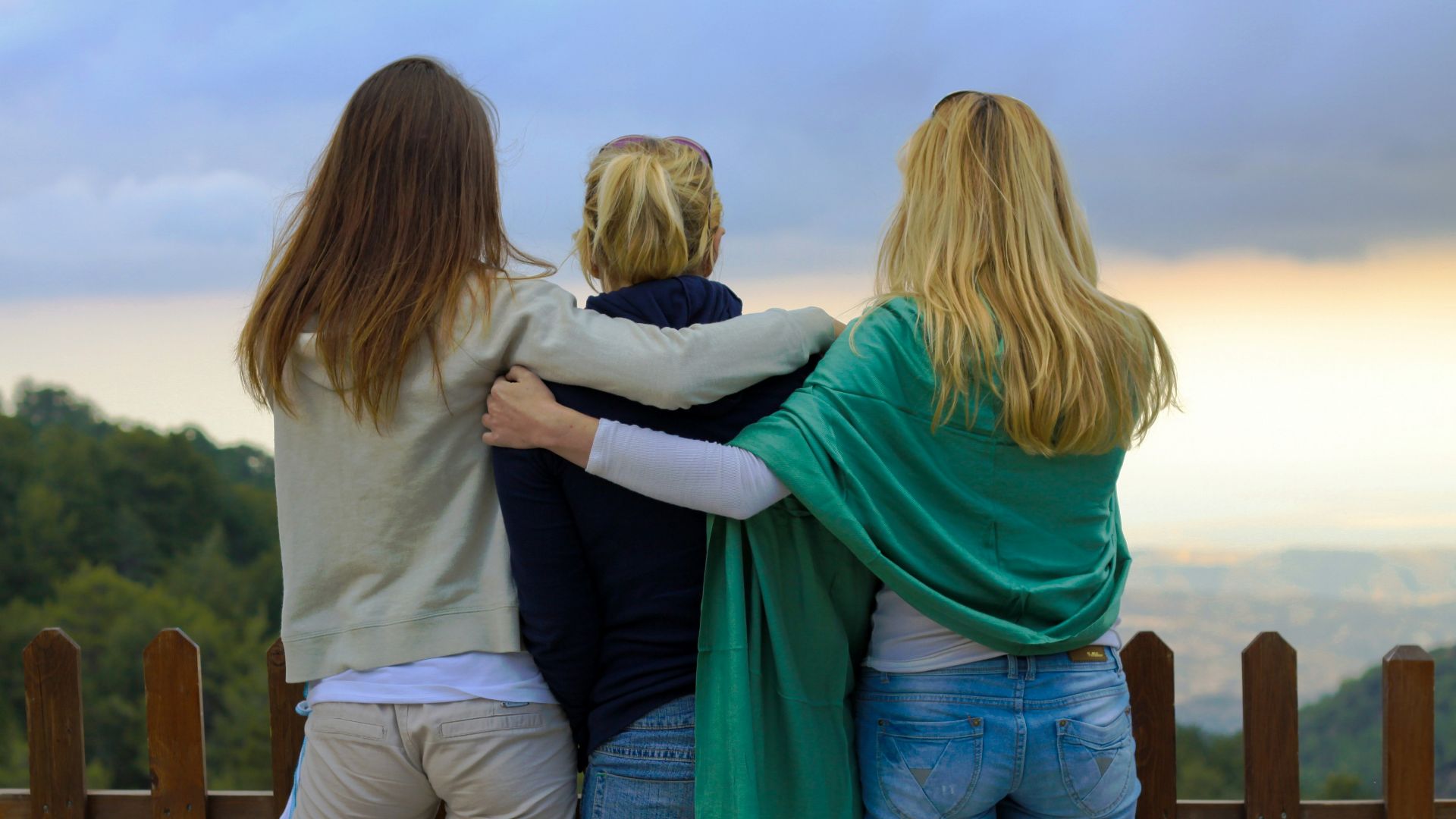 a group of three women standing next to each other