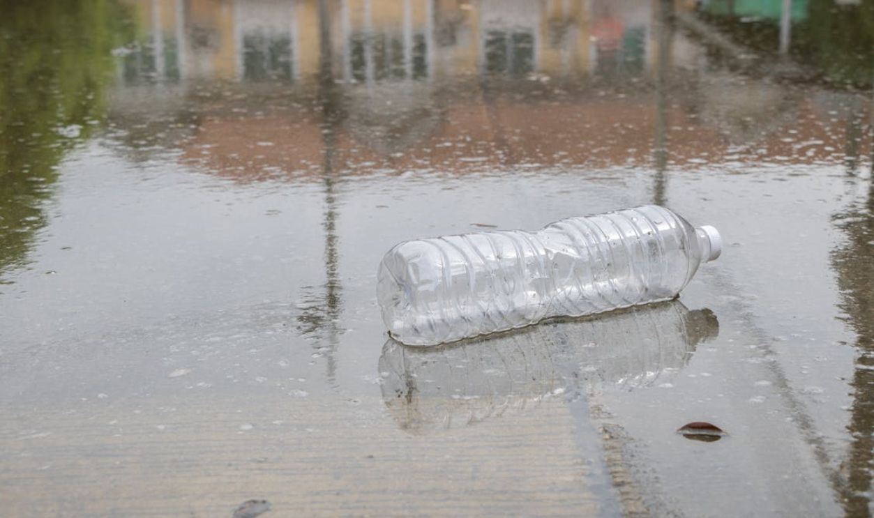 Clear Plastic Bottle on Wet Ground