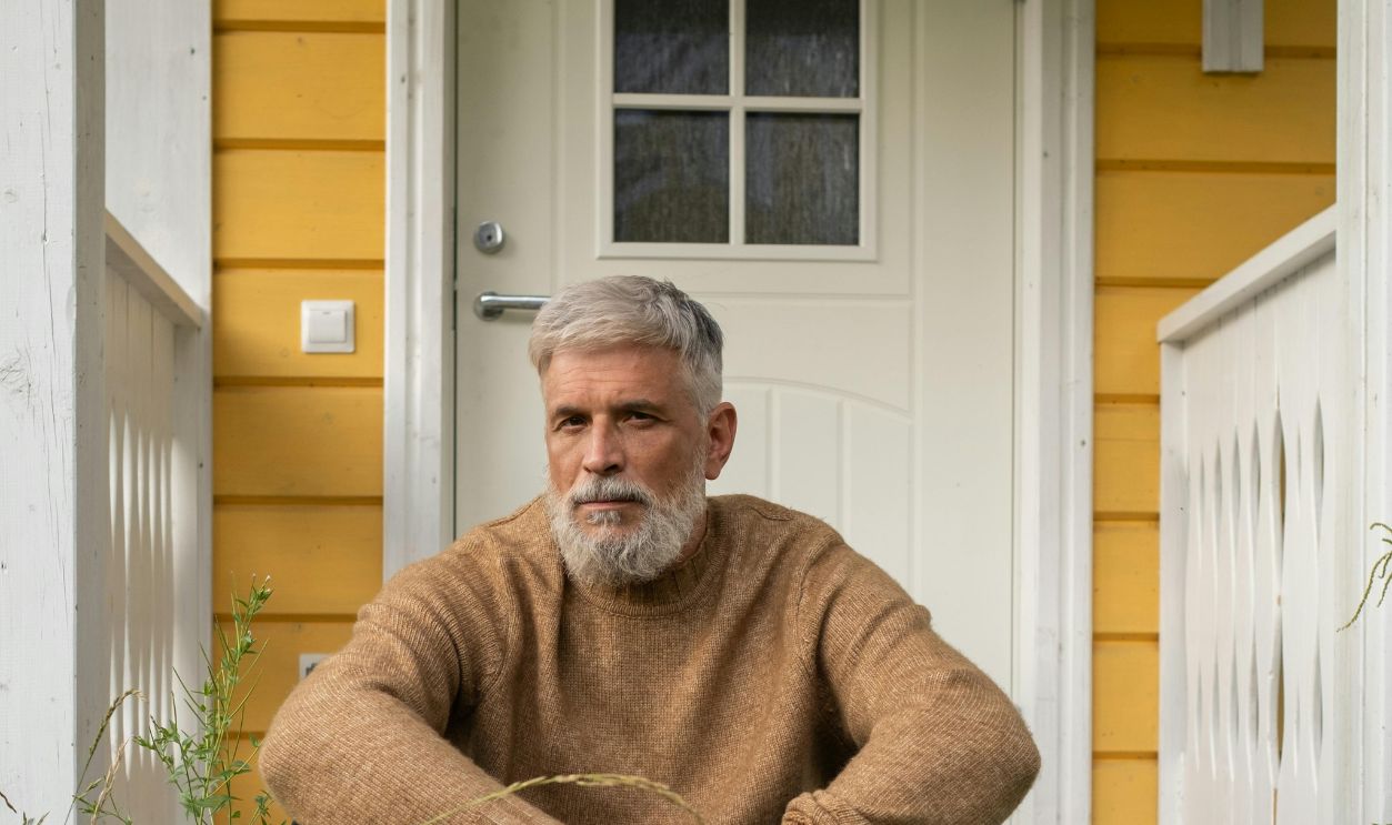 Elderly Man Sitting On Porch