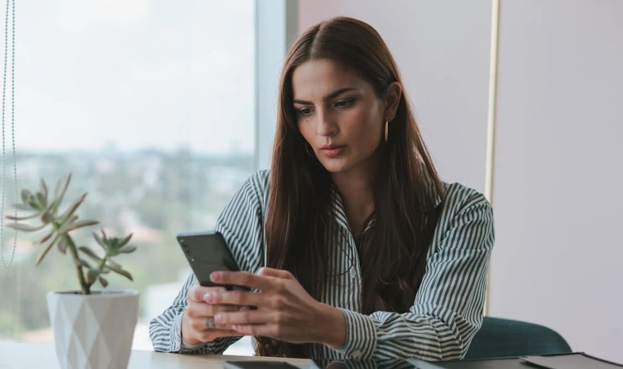 Portrait of Brown Haired Woman Using Phone in Office
