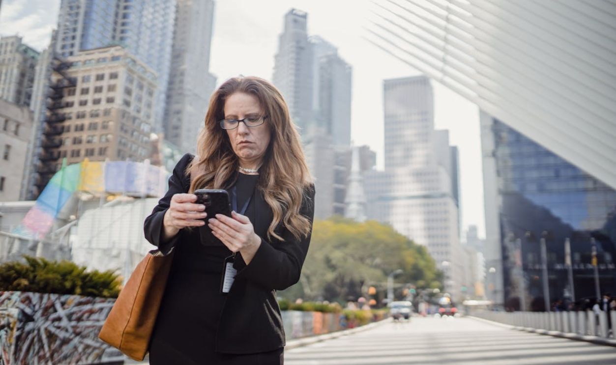 Woman Standing on a Street Using her Phone