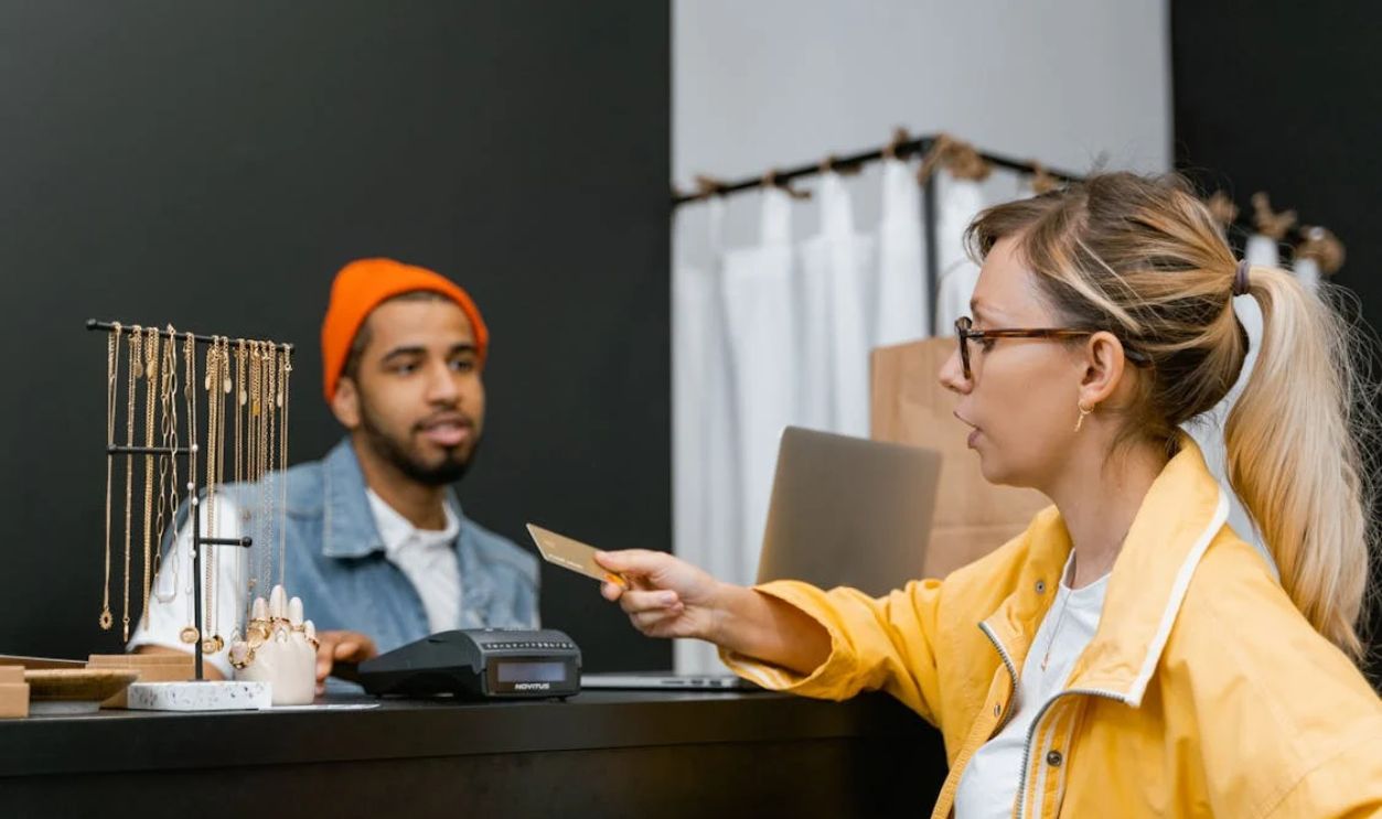 A Woman Using a Credit Card in a Store