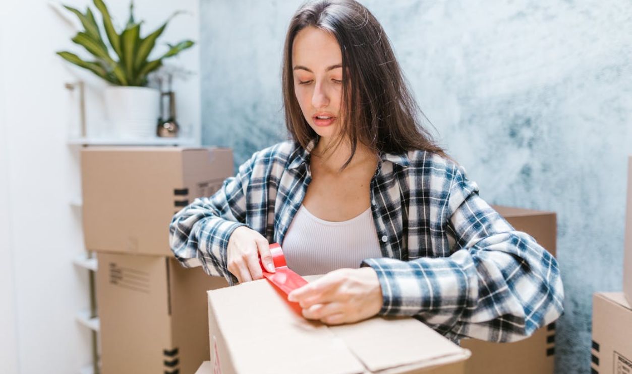 Woman Packing Moving Boxes