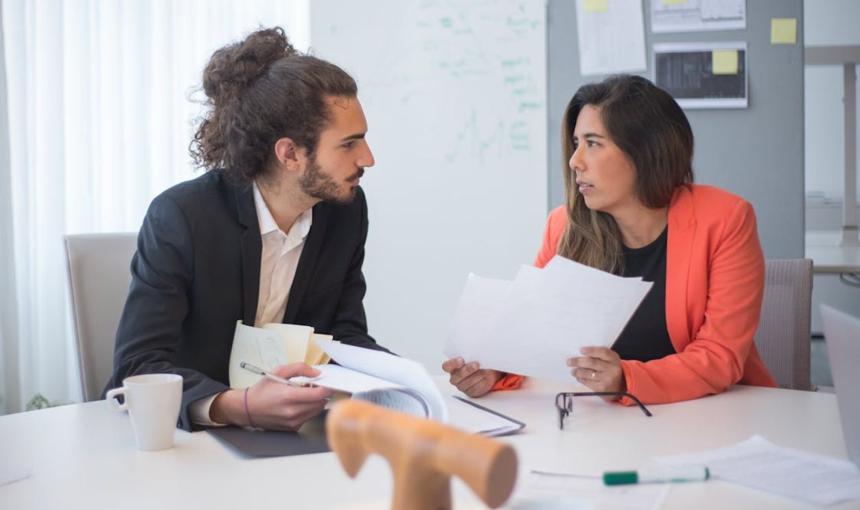 Bearded Man Talking to a Woman at the Office