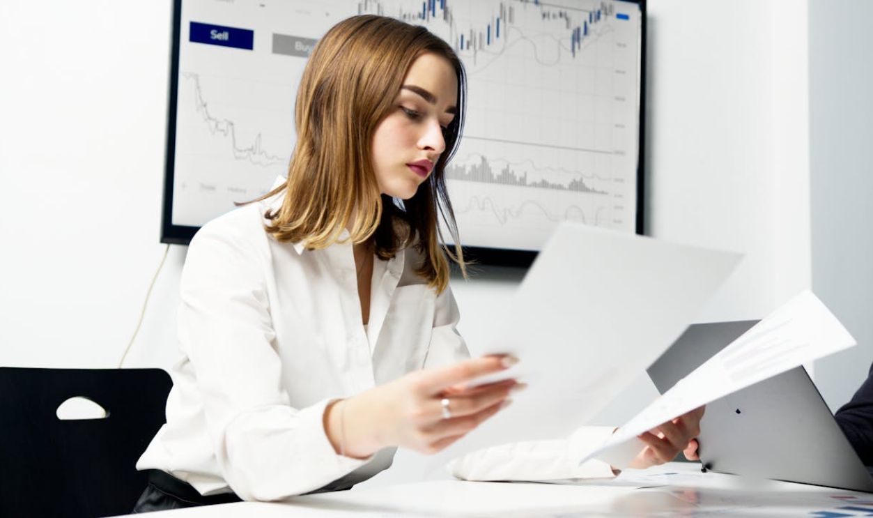 A Woman in White Dress Shirt Holding Pieces of Paper