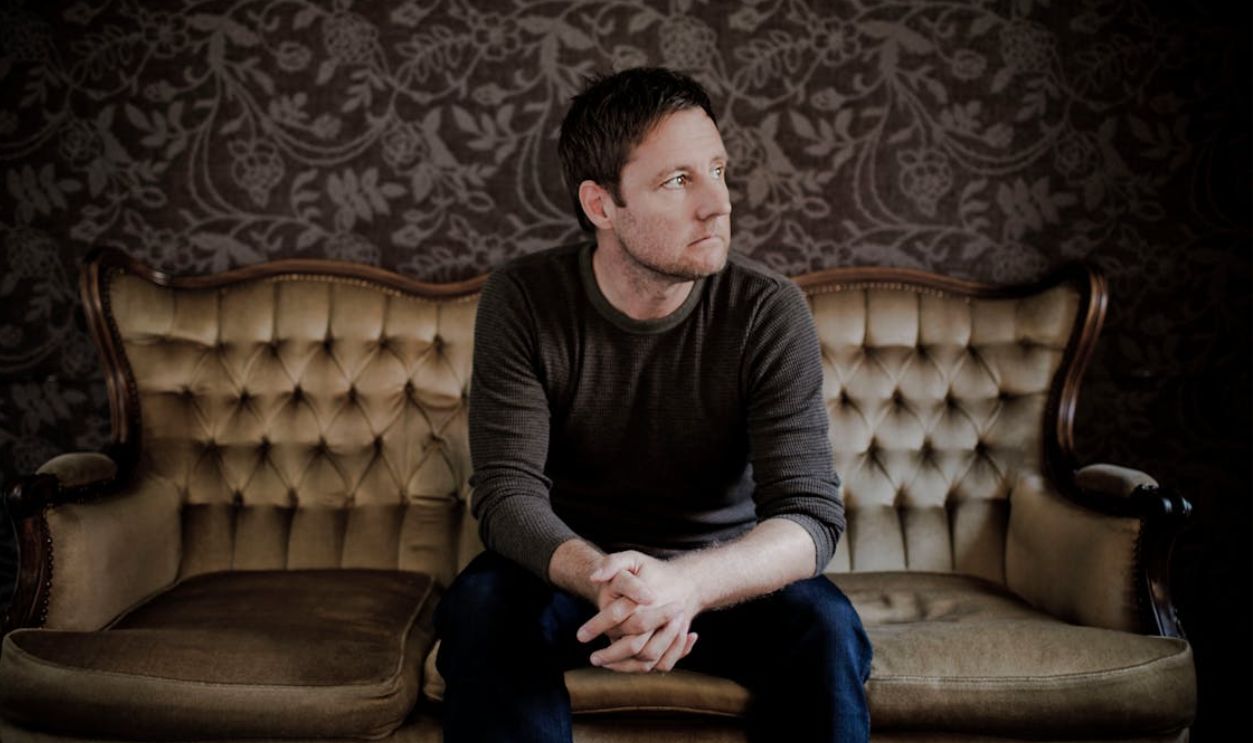 Man Sitting On Couch