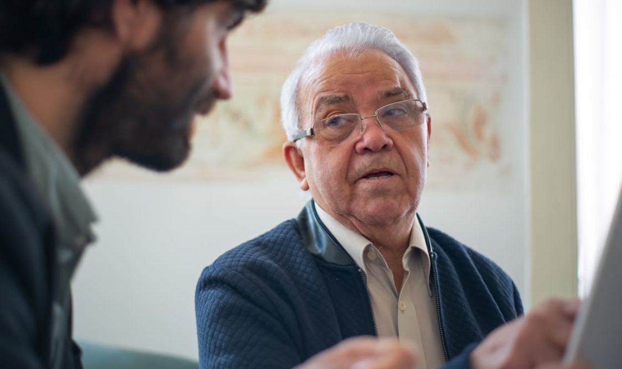 Man in Blue Jacket Wearing Eyeglasses
