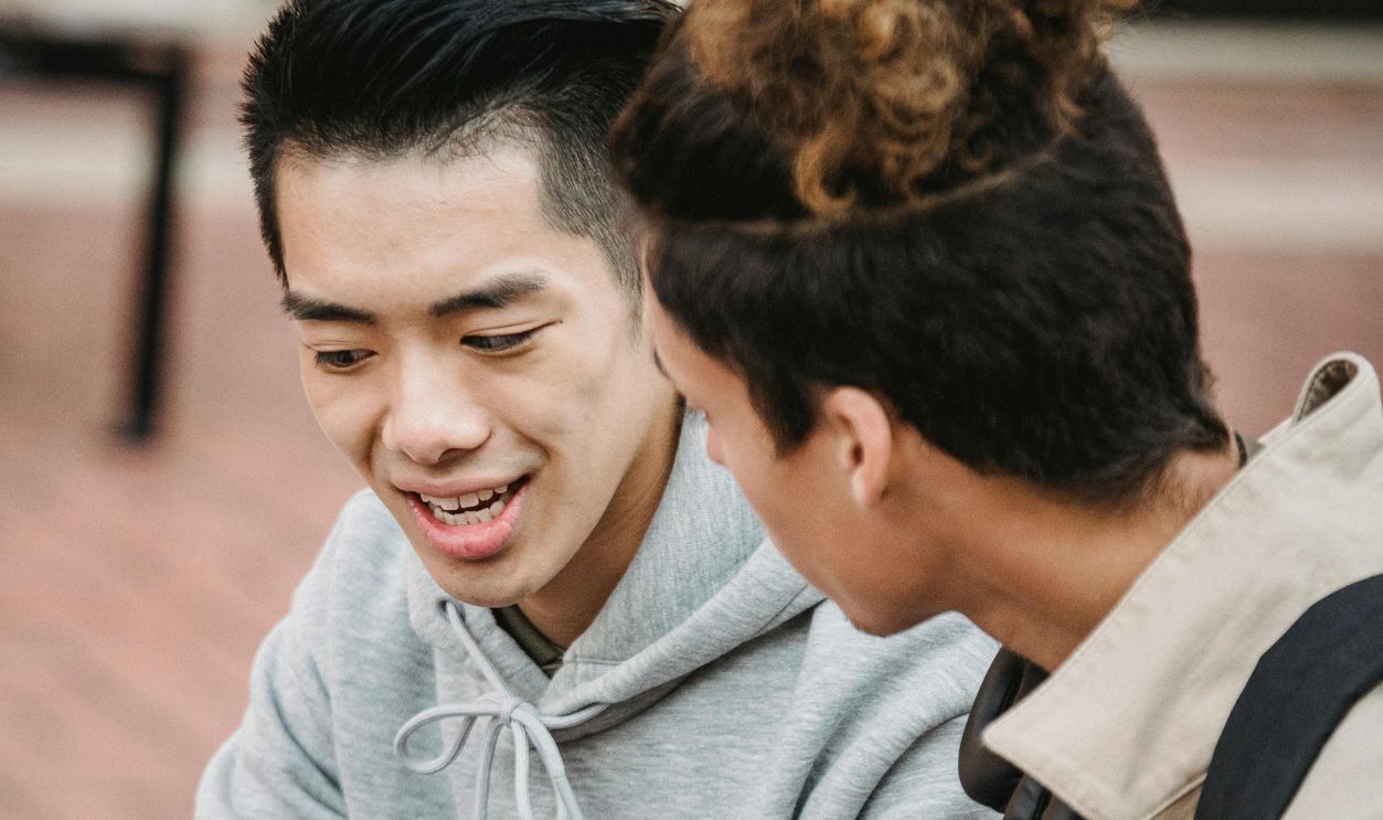 Serious students with laptop discussing assignment