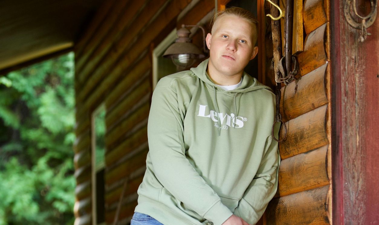 Man Leaning on Wooden Wall