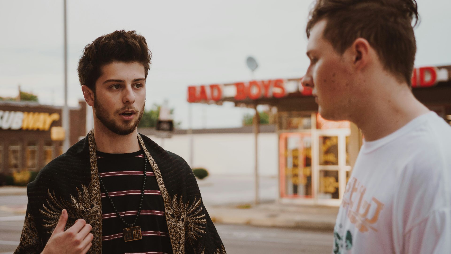 man talking to another man