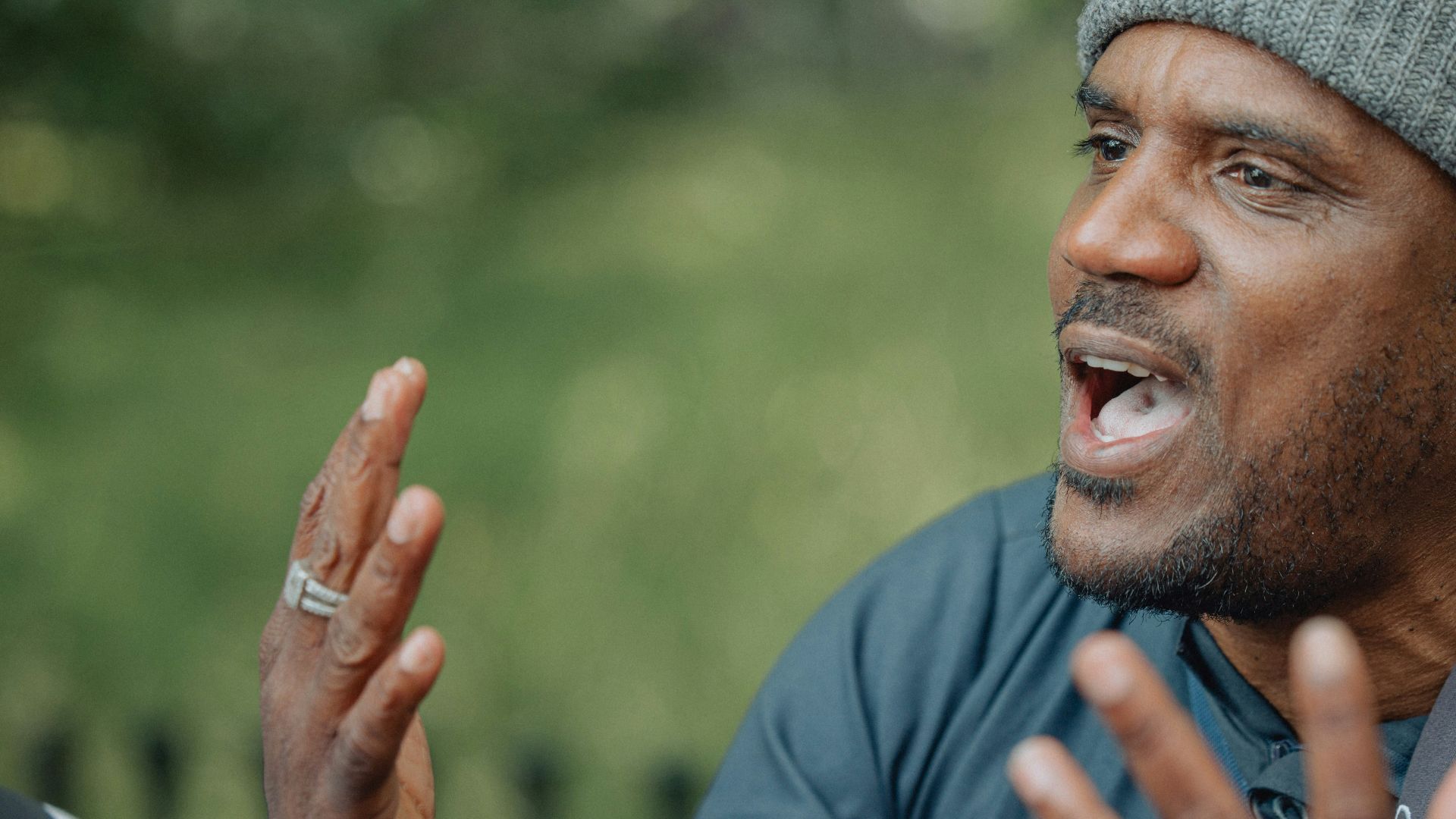 A man is talking passionately to others.